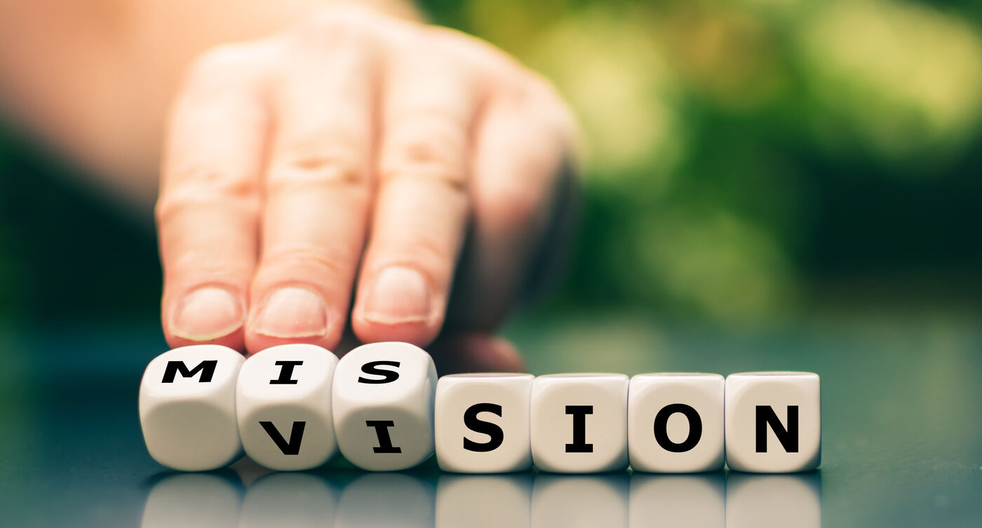 Dice being turned from the word mission to the word vision