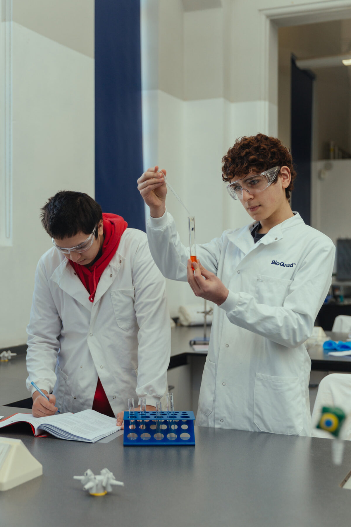 Students in lab coats carrying out an experiment