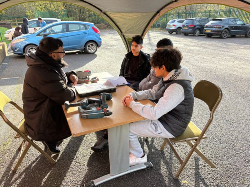 Mr Abid Ali, Pastoral Leader, working with students outdoors